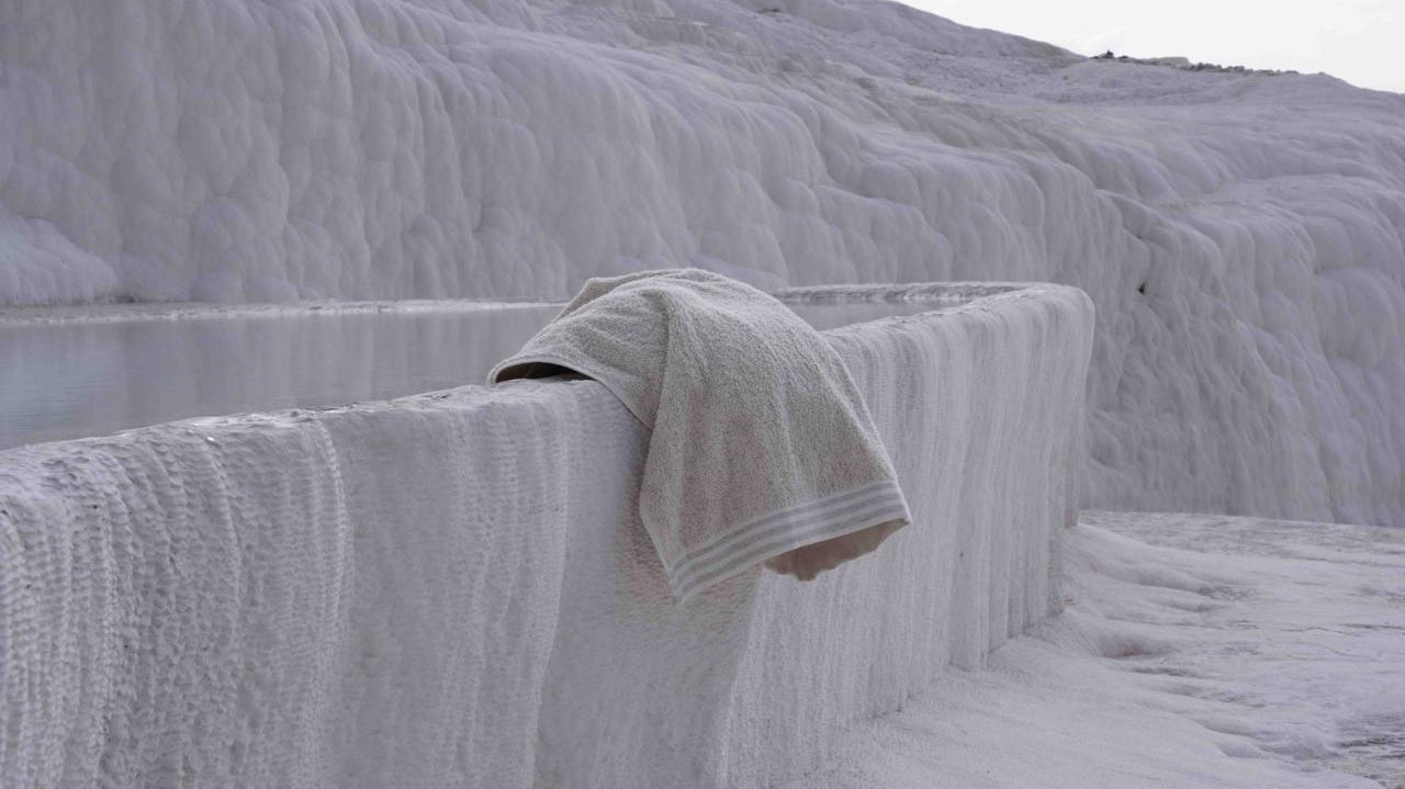 A piece of Minoa towel hanging on the edge of a rock