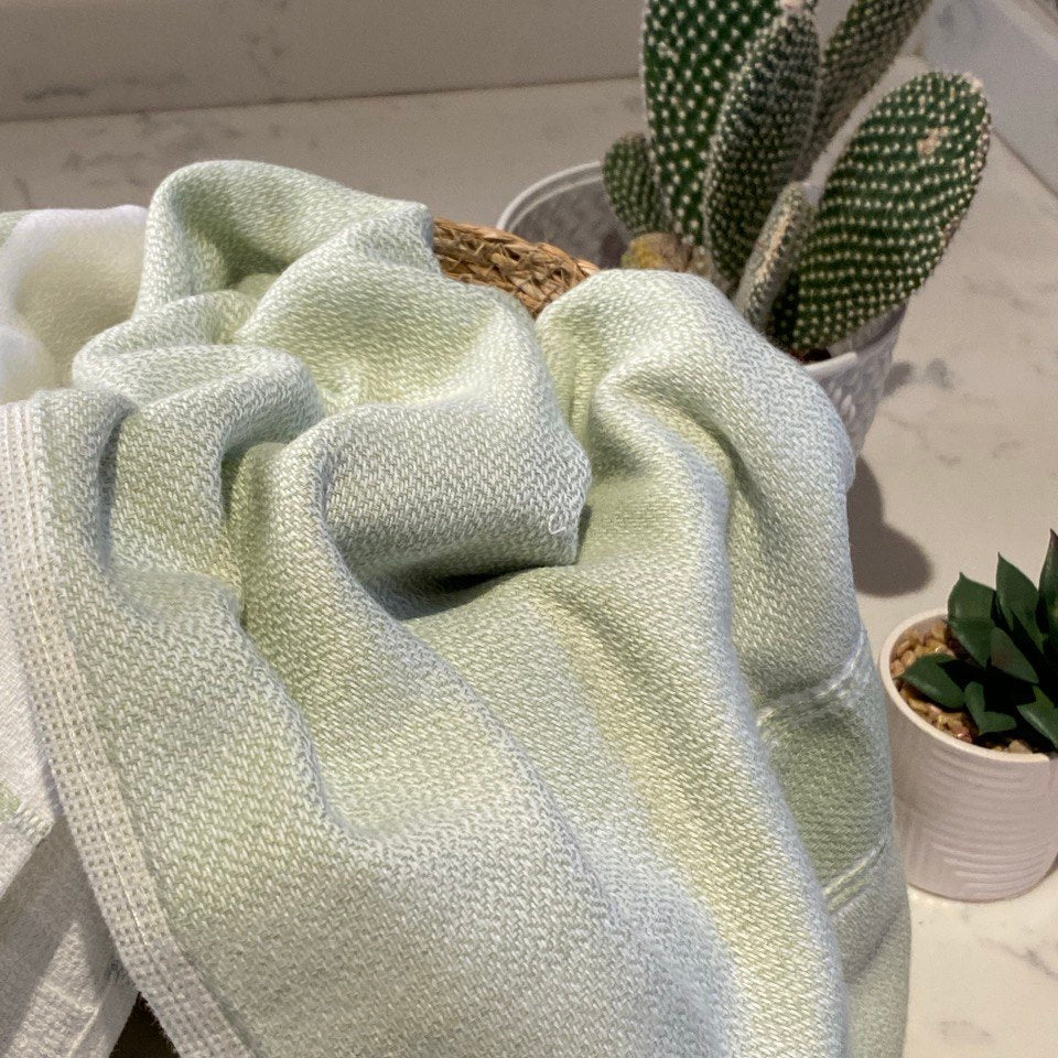Lime towel in a basket on a kitchen counter