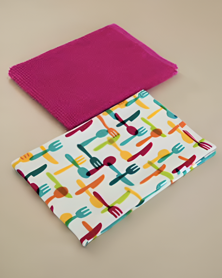 Colourful kitchen towel with cutlery pattern and pink napkin on a beige background