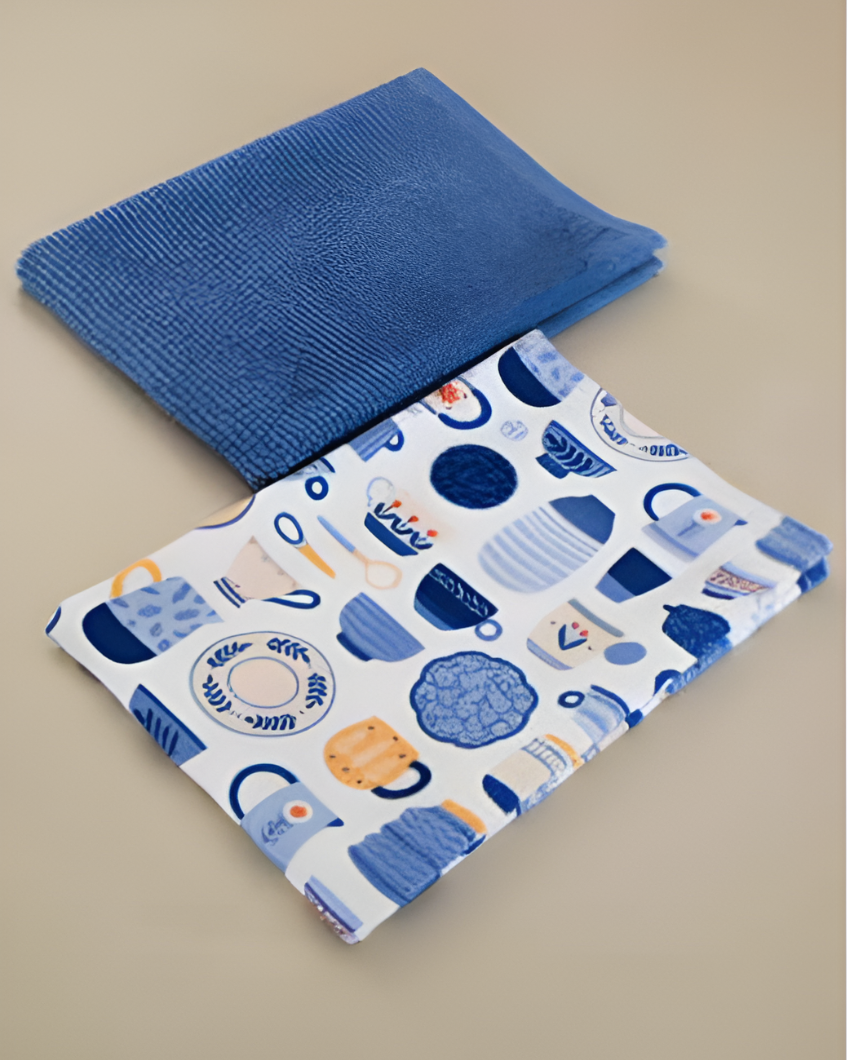 Blue textured kitchen towel and patterned blue and white fabric on a beige background