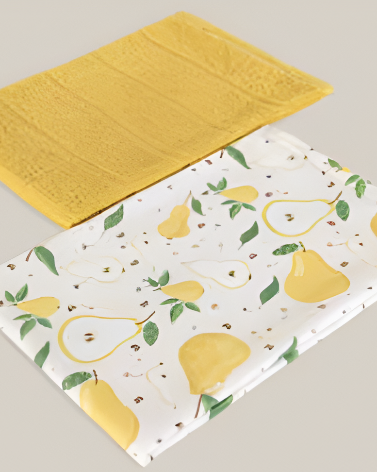 Two kitchen towels on a neutral background, one yellow and one with pear pattern