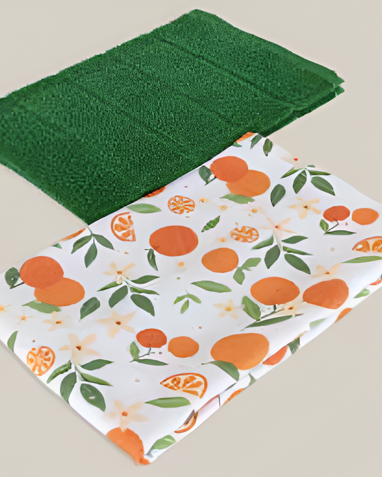 Green kitchen towel and one kitchen towel with orange pattern on a beige background