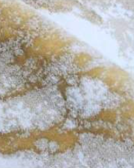 Warm and inviting ecru and beige bath rug, complemented by a soft latte hue, providing a cozy atmosphere to your bathroom