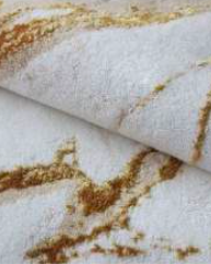 Luxurious ecru and beige bath rug with rich gold accents, adding a touch of opulence and elegance to your bathroom
