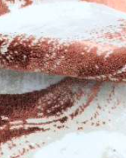 Delicate rose-colored bath rug in ecru and beige, offering a soft, feminine touch to your bathroom decor