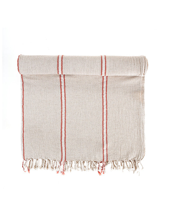 Textured towel with red stripes and frayed edges on a white background