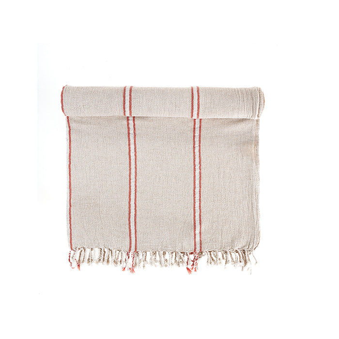 Textured towel with red stripes and frayed edges on a white background