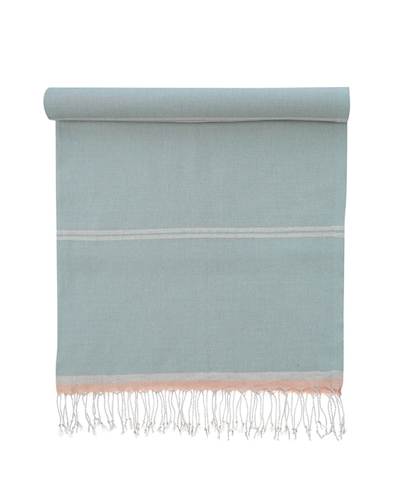 Light blue towel with white stripes and fringes on a white background