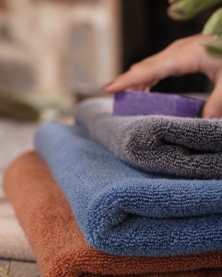 Plush Lite 500-Gram Aegean Cotton Large Hand Towels in Charcoal Embrace, Blue Velvet, and Cinnamon Charm, neatly folded, showcasing their soft texture and rich colours
