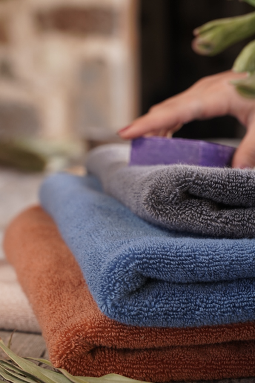 Plush Lite 500-Gram Aegean Cotton Large Hand Towels in Charcoal Embrace, Blue Velvet, and Cinnamon Charm, neatly folded, showcasing their soft texture and rich colours
