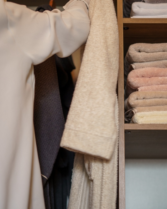 Monte Rosa 820-gram Aegean Cotton XL sheet set by Minoa USA Canada, neatly stacked on a wooden shelf, highlighting plush texture, natural elegance, and premium organic sheets quality