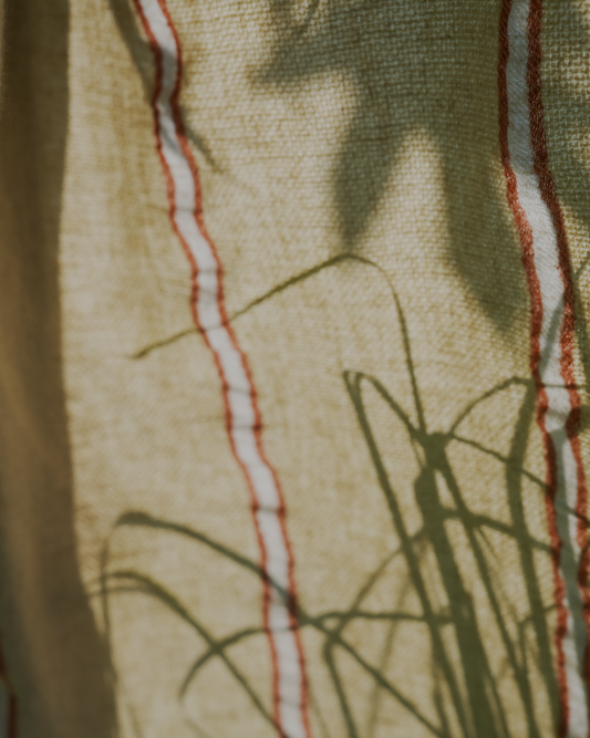 Close up of orange and white Anakao 215 gram Aegean Cotton and Linen Turkish towel showcasing its delicate texture and organic bath towel quality