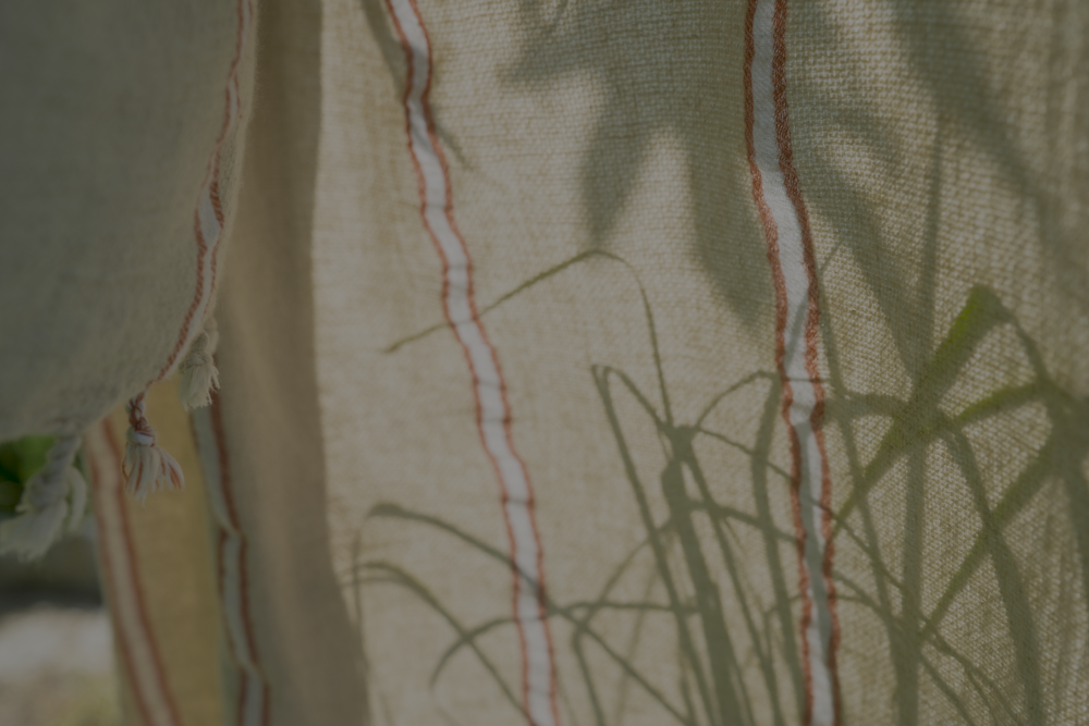 Close up of orange and white Anakao 215 gram Aegean Cotton and Linen Turkish towel showcasing its delicate texture and organic bath towel quality