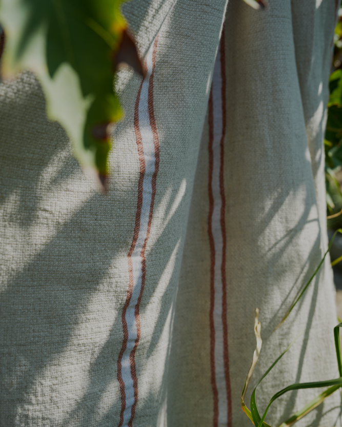 Natural eco friendly orange and white Anakao 215 gram Aegean Cotton and Linen Turkish towel highlighting its organic bath towel quality