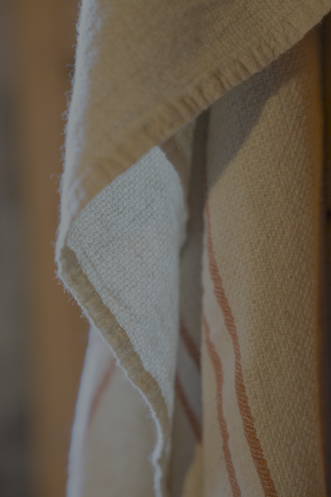 Luxuriously soft natural Anakao 215 gram Aegean Cotton and Linen Turkish towel hanging on the wall showcasing luxury bath towel quality