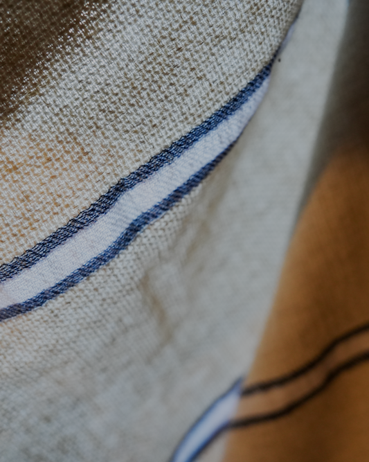 Close up of blue and white Anakao 215 gram Aegean Cotton and Linen Turkish towel showcasing its soft texture and quality as an organic bath towel