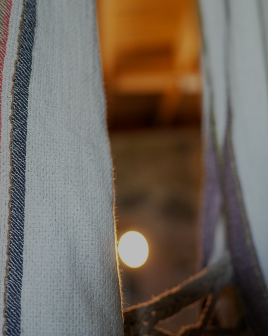 Two luxury organic Elba Turkish towels supporting circular economy hanging on a cloth hanger