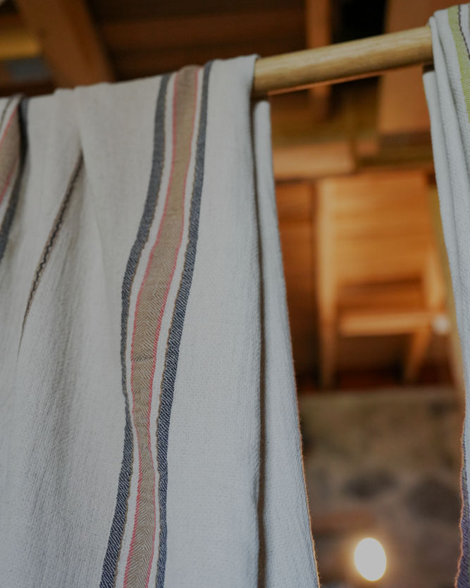 Organic bath towel from the luxury Elba Turkish collection hanging on a cloth hanger in a room