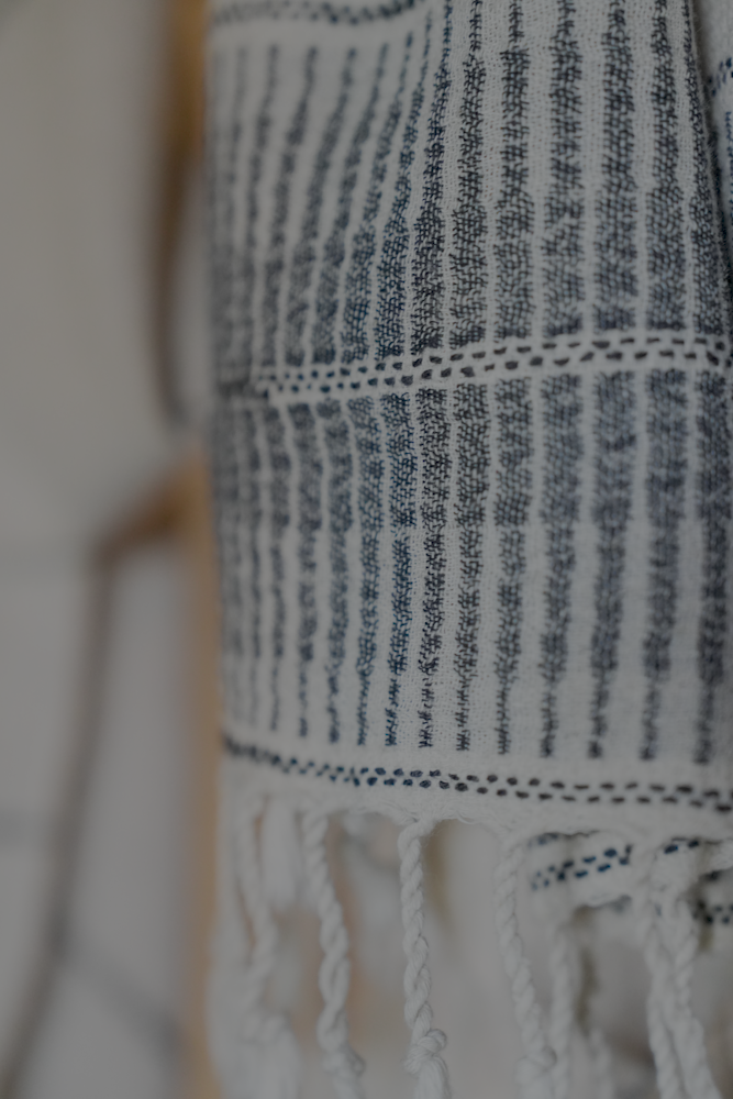 Close-up of Minoa's luxuriously soft, sustainable organic Palawan 220-gram linen Turkish bath towel in black, highlighting plush texture and premium quality