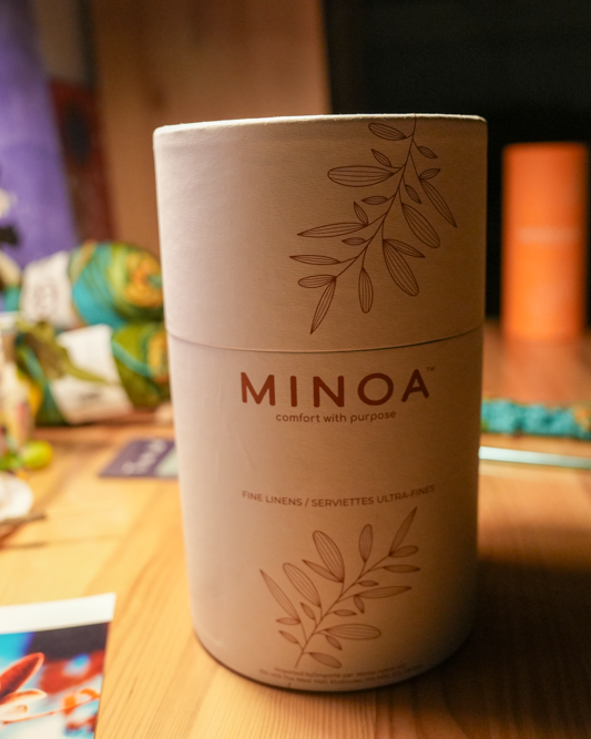 Close-up of Plush Lite 500-Gram Aegean Cotton luxury bath towels guest bath and hand towel set in a luxurious white cylinder case