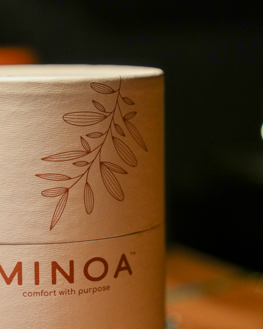 Plush Lite 500-Gram Aegean Cotton Large Bath & Hand Towel Set placed in a white luxury cylinder case