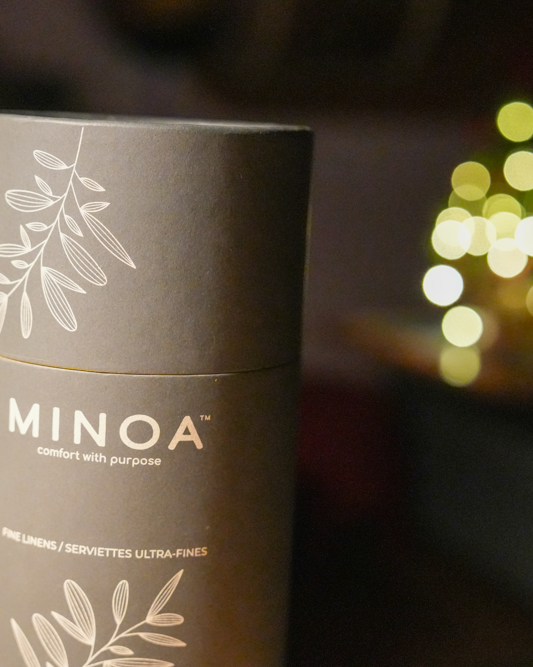 Close-up of Plush Lite 500-Gram Aegean Cotton luxury bath towels guest bath and hand towel set in a luxurious dark navy green cylinder case