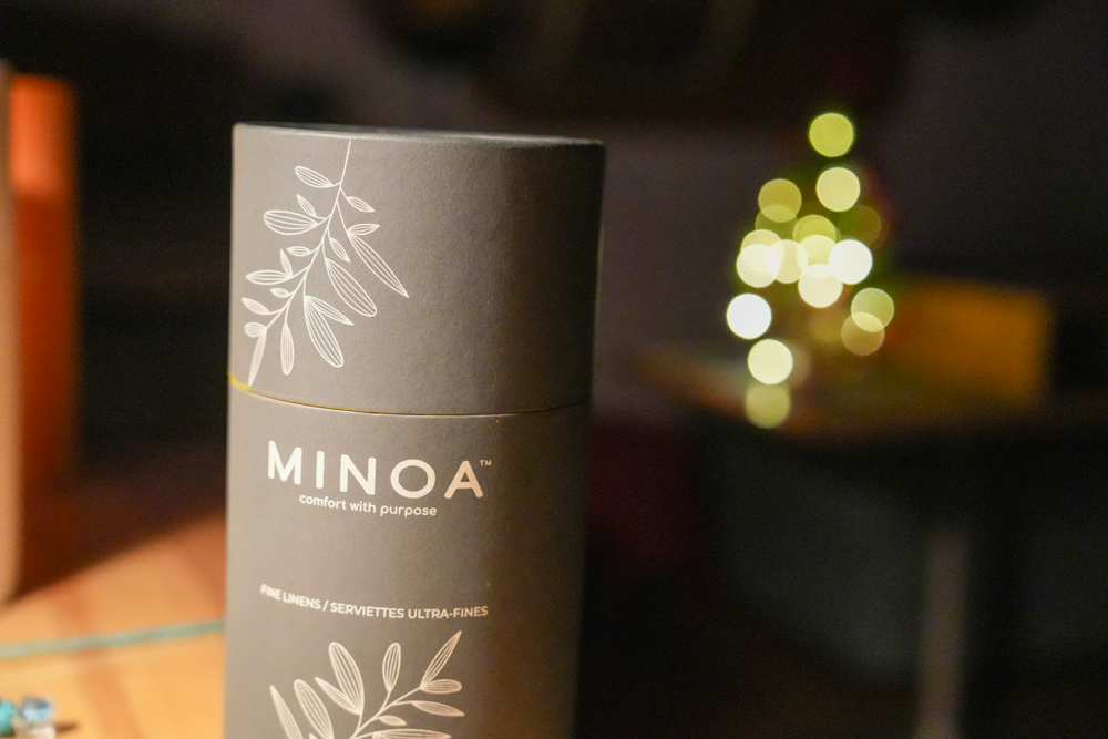 Close-up of Plush Lite 500-Gram Aegean Cotton luxury bath towels guest bath and hand towel set in a luxurious dark navy green cylinder case