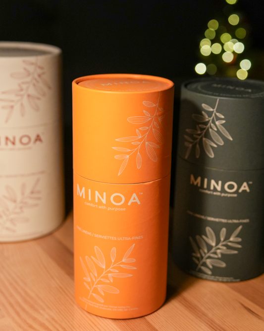 Plush Lite 500 gram Aegean Cotton organic bath towels guest bath and hand towel set elegantly presented in cylinder cases in white orange and dark navy green highlighting the premium quality of luxury bath towels and sustainable design