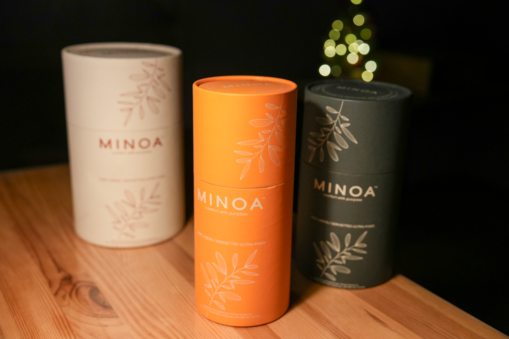 Plush Lite 500 gram Aegean Cotton organic bath towels guest bath and hand towel set elegantly presented in cylinder cases in white orange and dark navy green highlighting the premium quality of luxury bath towels and sustainable design