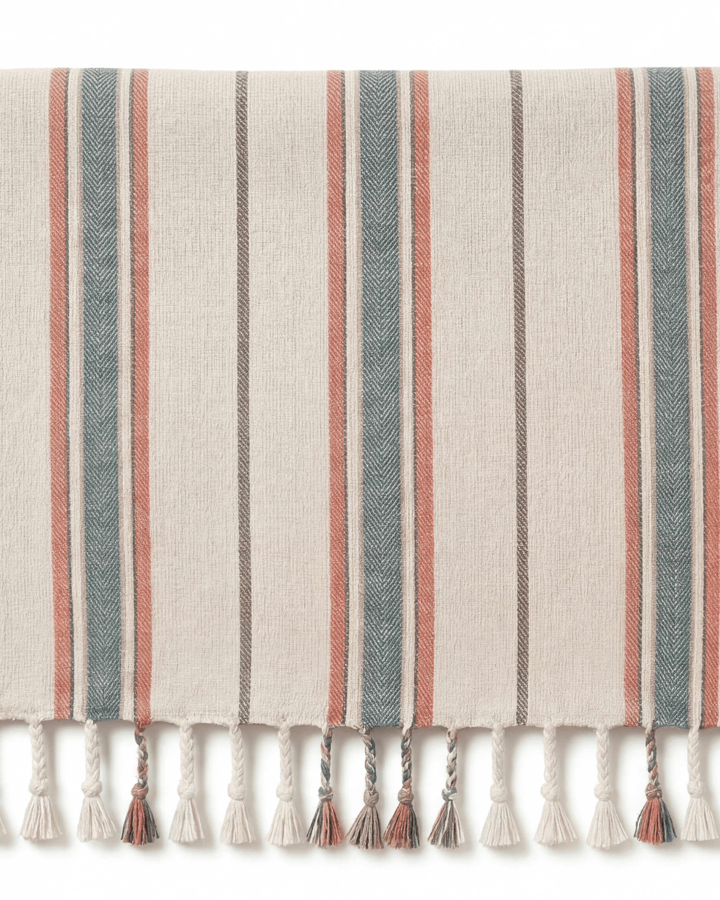 A striped Turkish towel with cream, slate blue, and terracotta stripes, finished with a fringed tassel edge. A small white label on the left edge reads 'Turkish Cotton'.