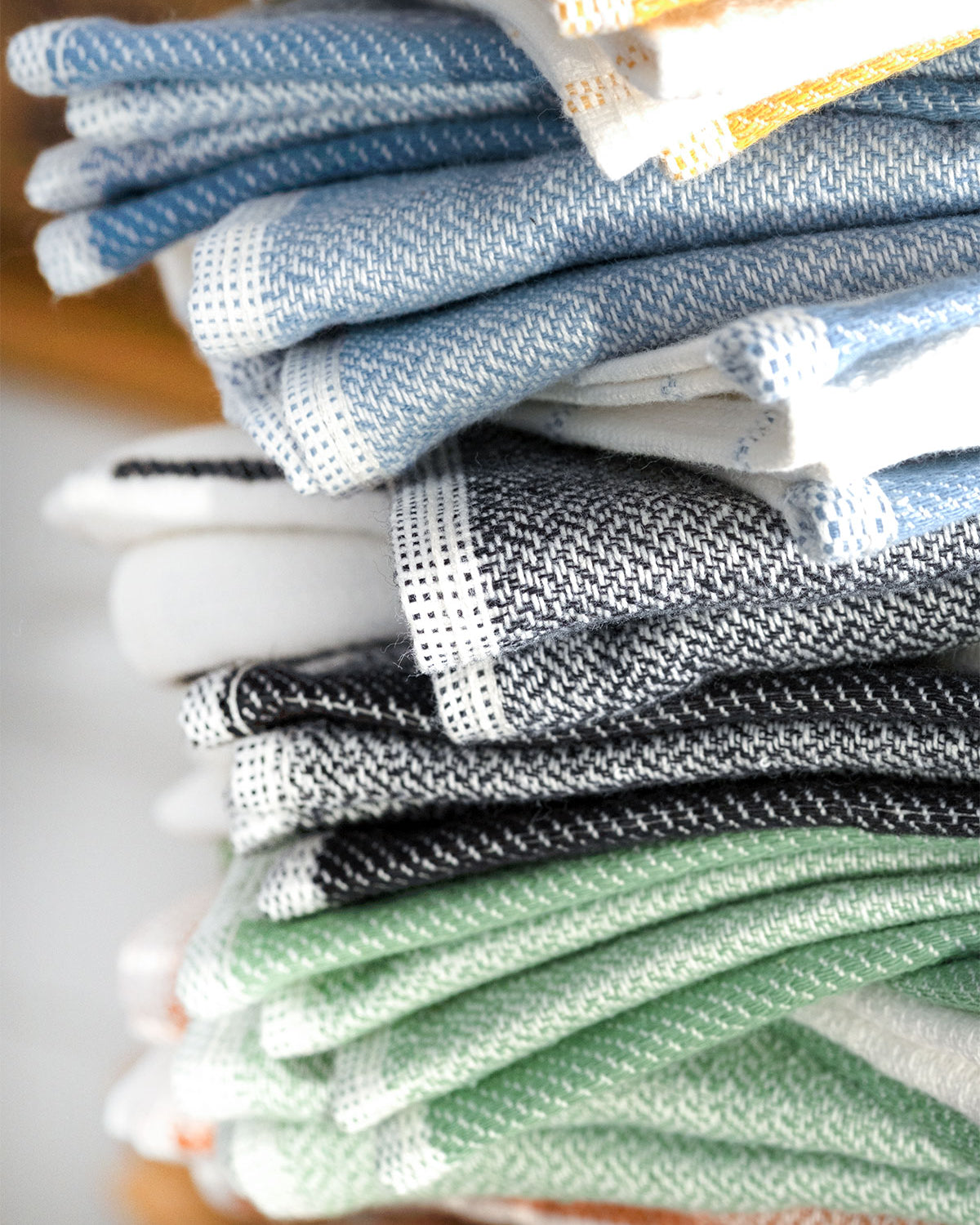 Close-up of the Elis Organic Aegean Cotton Kitchen Towel set of 3, featuring Lime Breeze, Silver Symphony, Midnight Velvet, Spice Serenade, Lemon Zest, and Serene Sky, neatly folded.