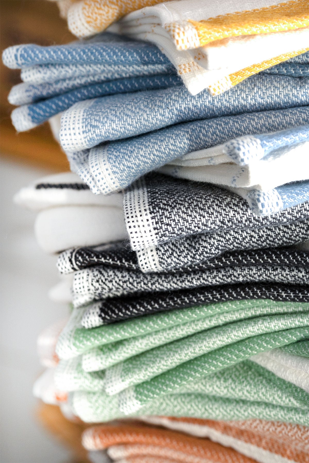 Close-up of the Elis Organic Aegean Cotton Kitchen Towel set of 3, featuring Lime Breeze, Silver Symphony, Midnight Velvet, Spice Serenade, Lemon Zest, and Serene Sky, neatly folded.