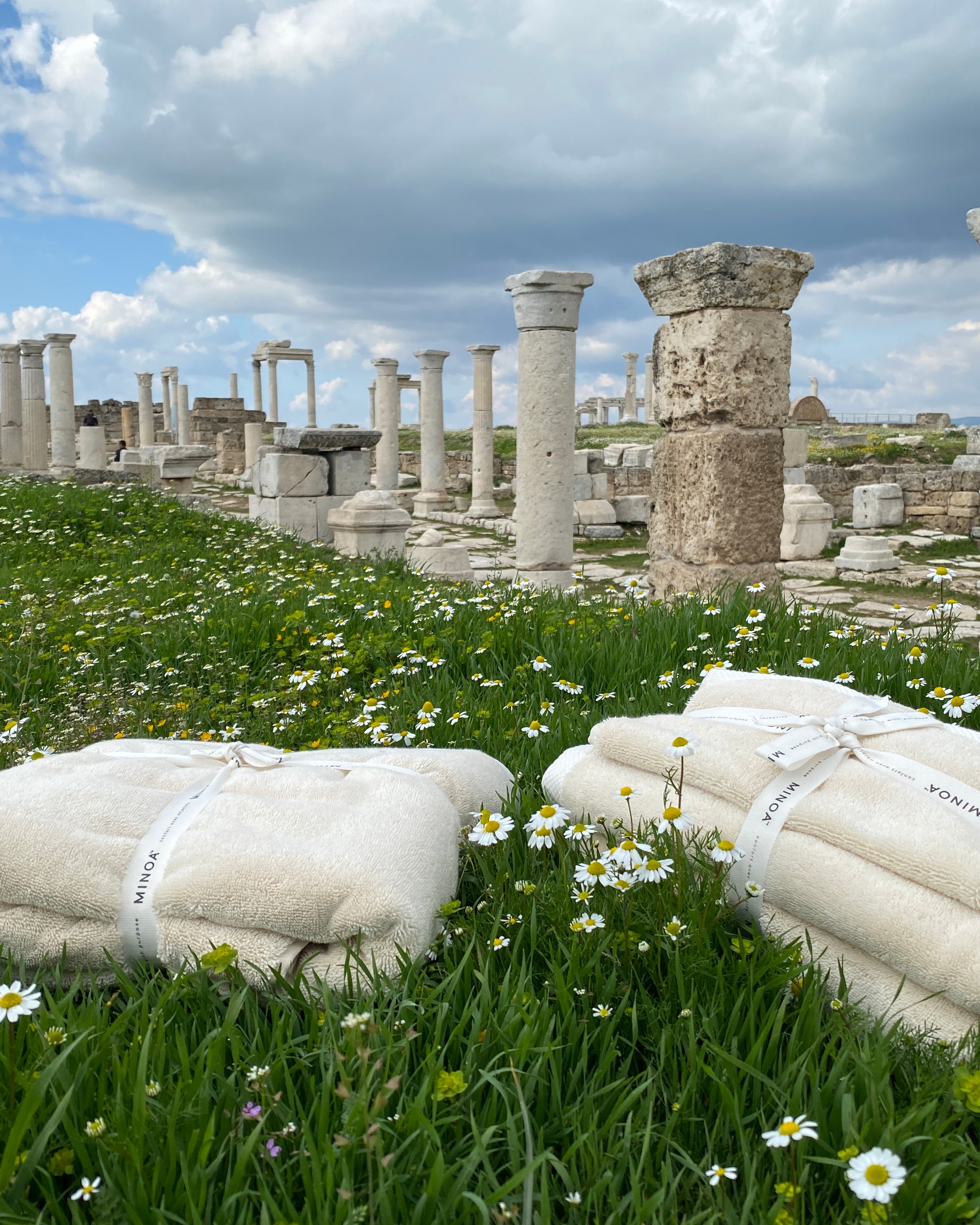 Two Raw Elegance Monte Rosa 820-gram organic Aegean cotton luxury bath towel sets gently placed on a natural background, highlighting soft plush texture and eco-friendly design