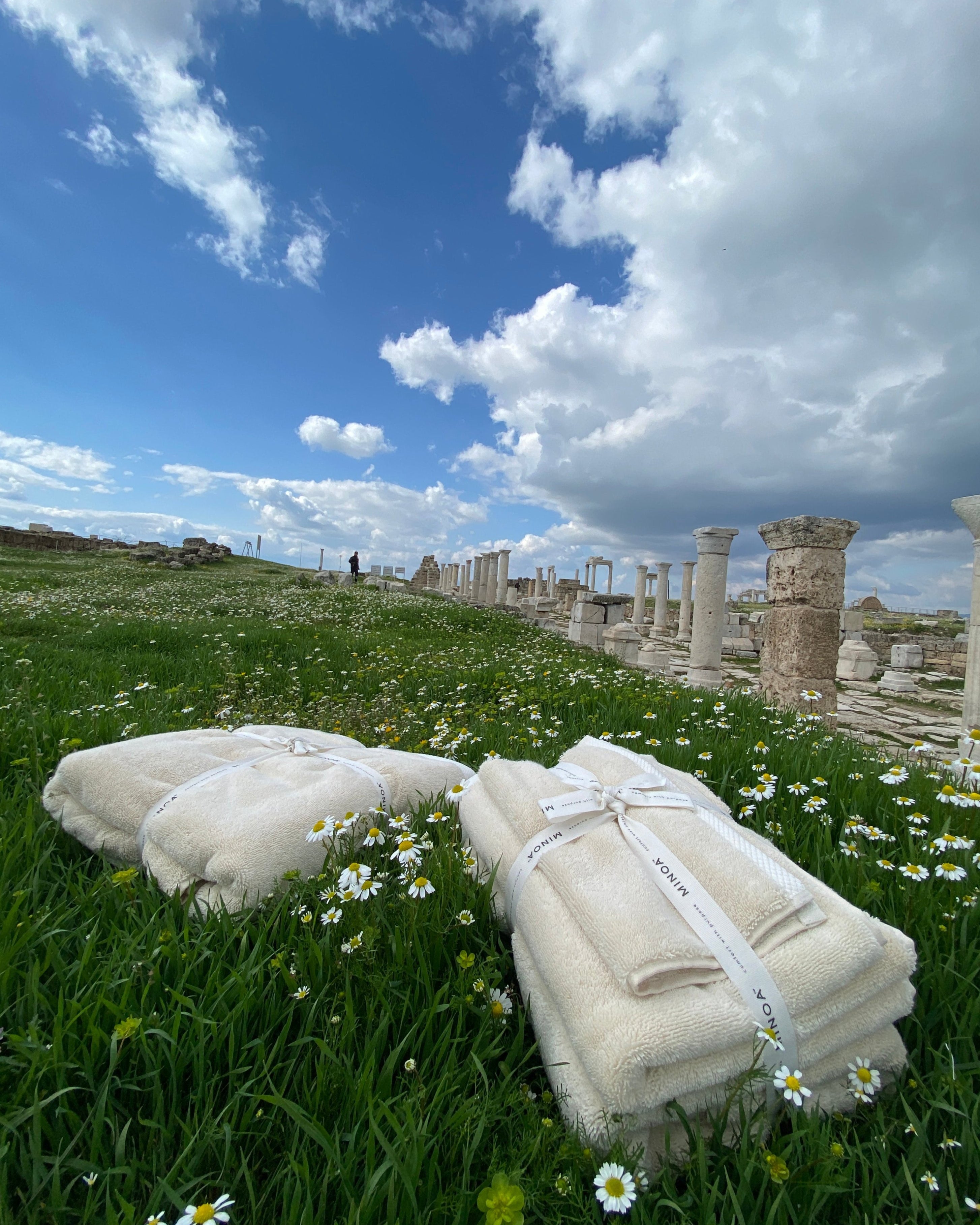 Two Moonlight Pearl Monte Rosa 820-gram organic Aegean cotton luxury bath towel sets gently placed on a natural background, highlighting soft plush texture and eco-friendly design