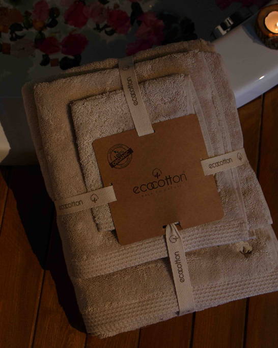 Jasper 600-gram organic Aegean cotton luxury bath, hand, and washcloth towel set in packaging, displayed with a spa background, highlighting soft texture, elegance, and sustainable luxury