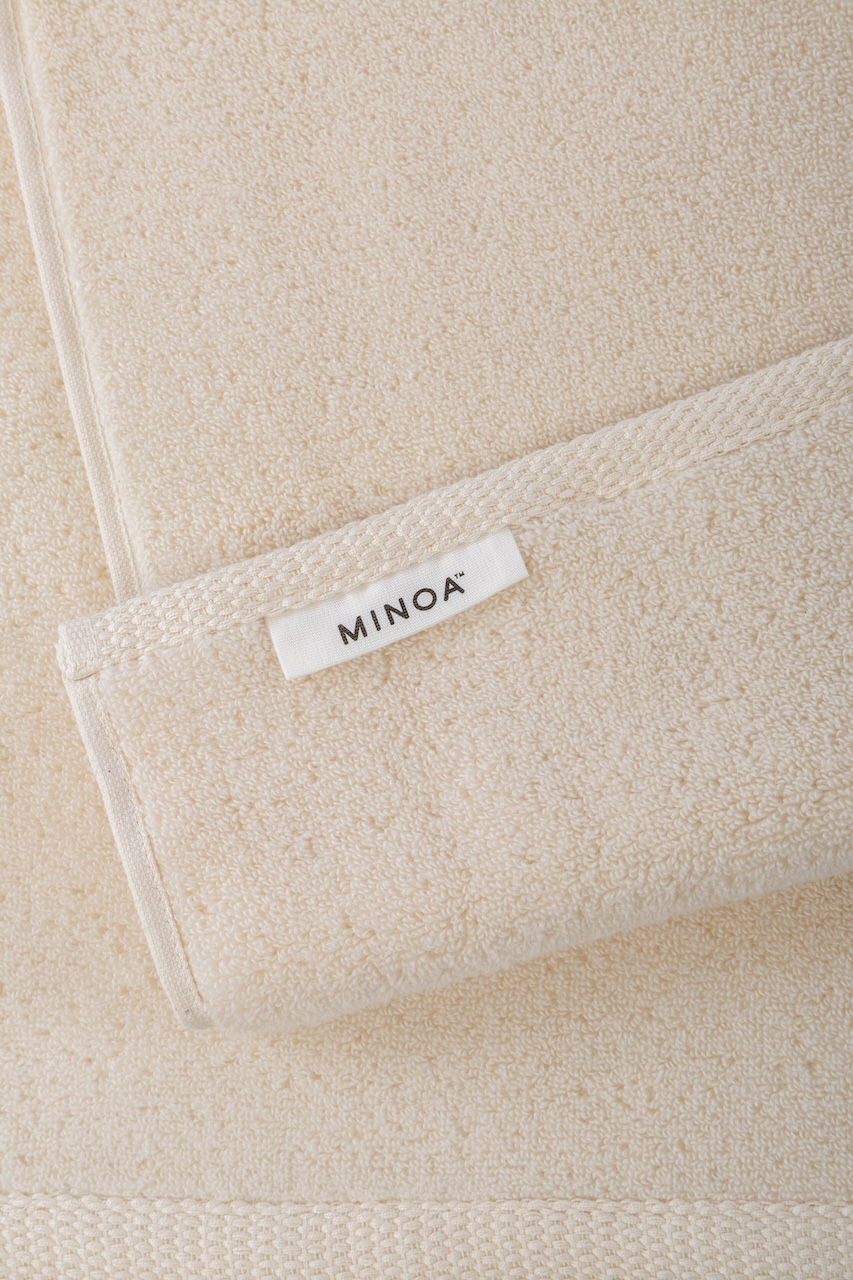 Close-up of Pure n Raw Plush Lite Aegean Cotton towel highlighting its natural off-white shade and soft, luxurious texture of organic bath towels