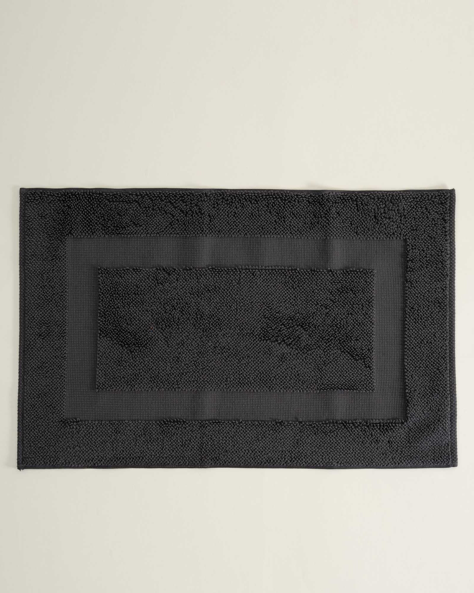 Kaia Aegean Cotton Bath Mat in Charcoal Charm, neatly placed, showing its rich colour, soft texture, and refined design