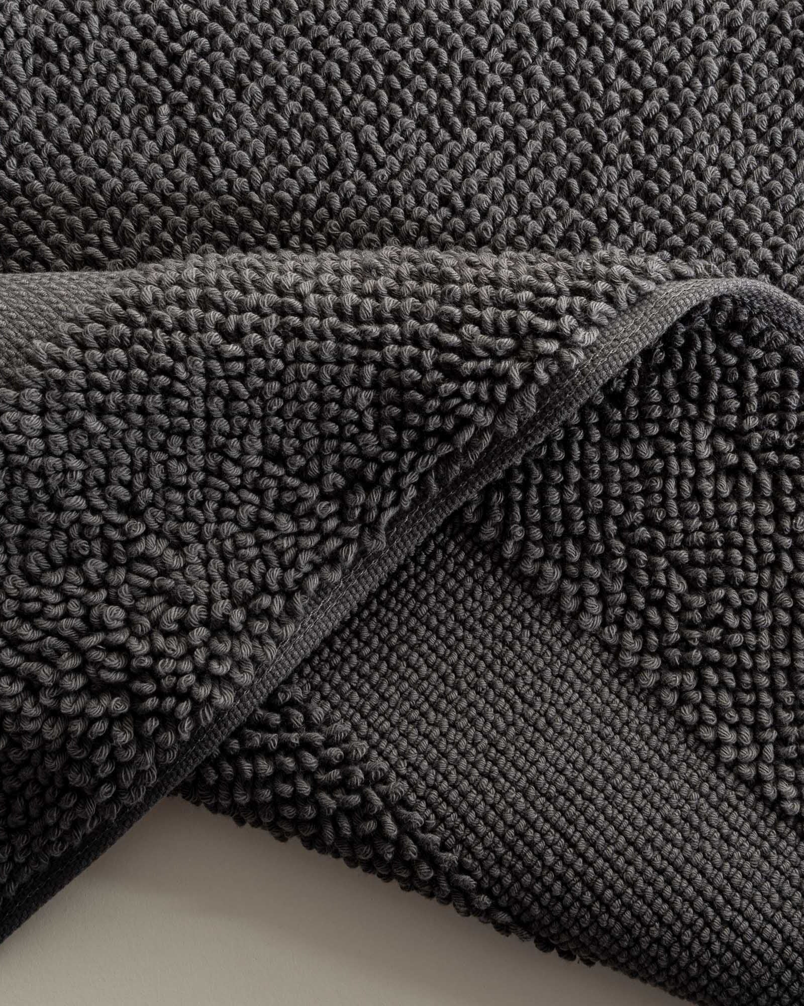 Close-up of the Kaia Aegean Cotton Bath Mat in Charcoal Charm, showcasing its rich colour, plush texture, and refined craftsmanship