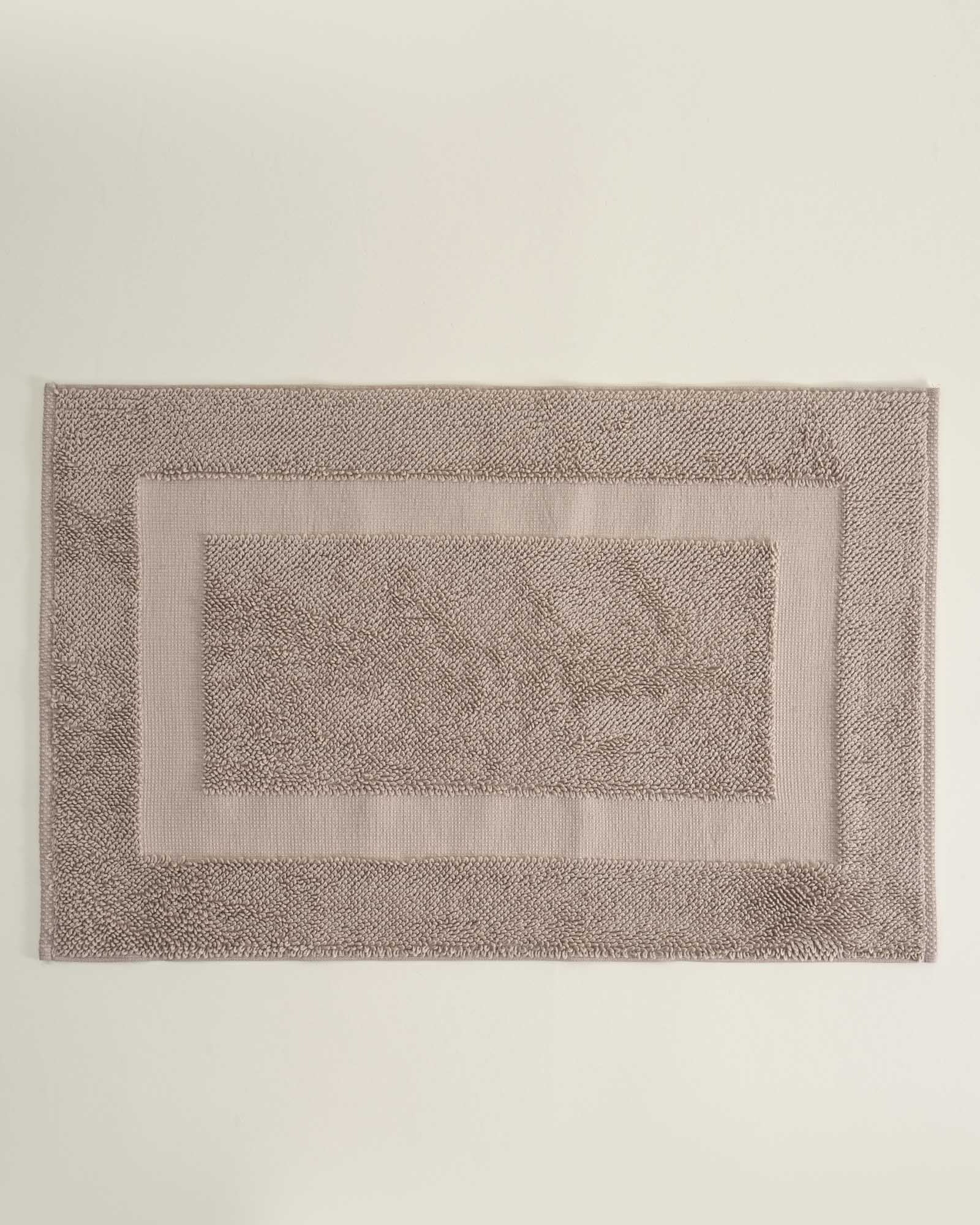 Kaia Aegean Cotton Bath Mat in Whispering Sands, showcasing its soft texture, warm hue, and luxurious quality