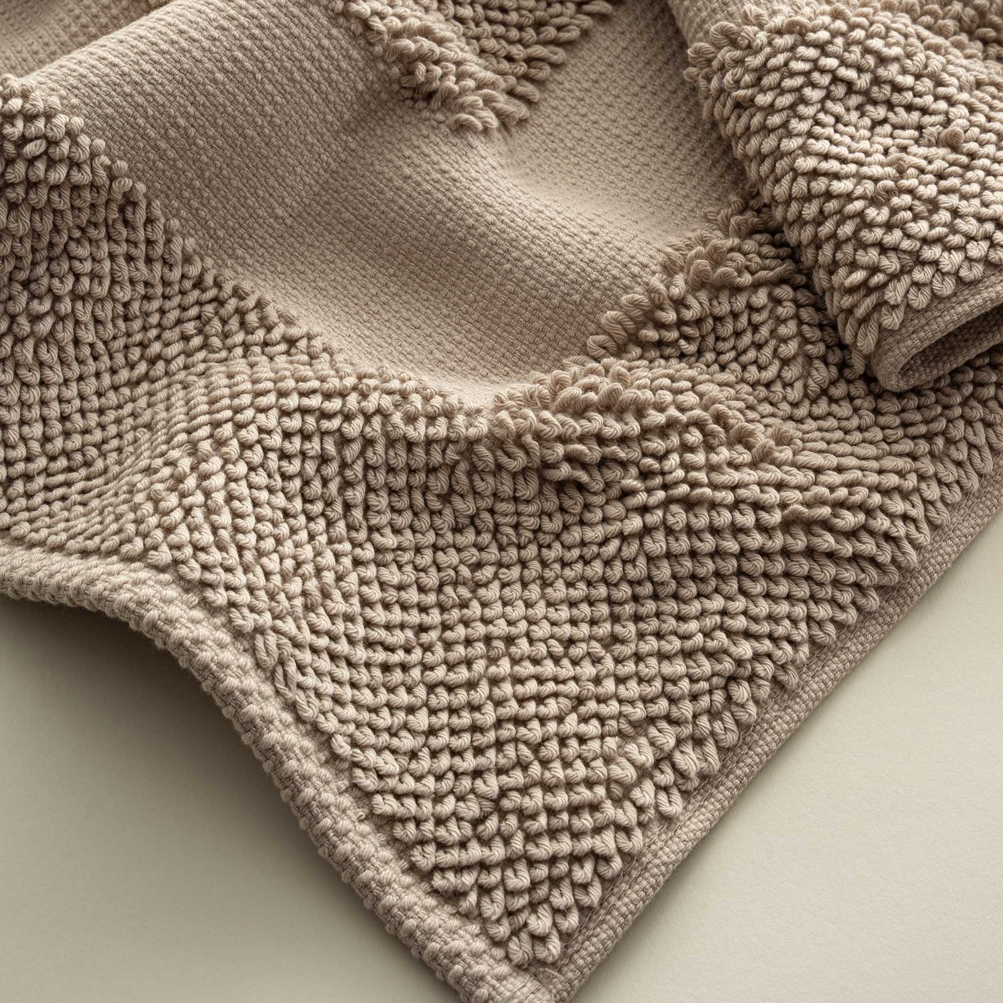 Close-up of the Kaia Aegean Cotton Bath Mat in Whispering Sands, highlighting its plush texture, subtle warmth, and high-quality craftsmanship