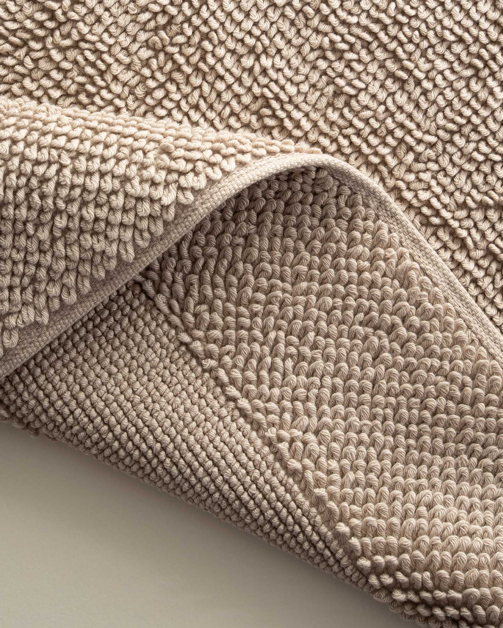 Close-up of the Kaia Aegean Cotton Bath Mat in Whispering Sands, highlighting its plush texture, subtle warmth, and high-quality craftsmanship