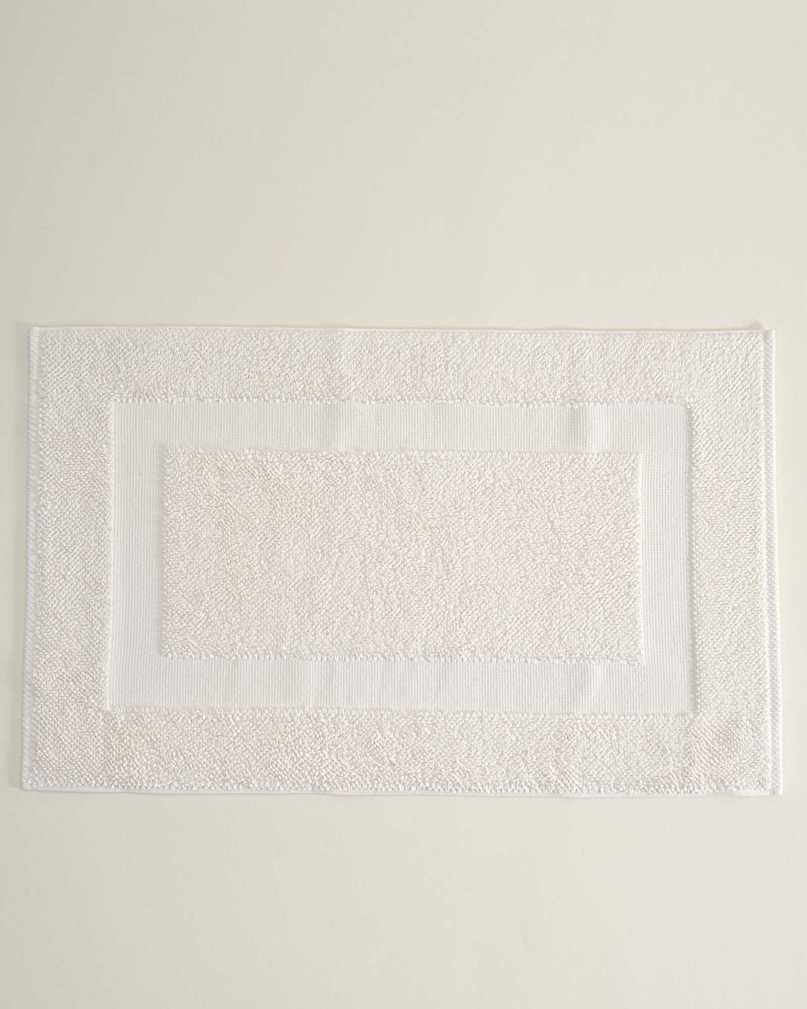 Folded Kaia Aegean Cotton Bath Mat in Pearl Petal, showing its soft texture, gentle hue, and refined craftsmanship