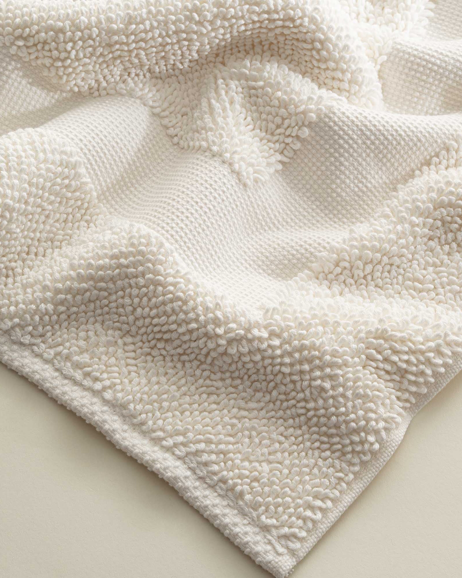 Close-up of the folded Kaia Aegean Cotton Bath Mat in Pearl Petal, showing its plush texture, soft colour, and quality finish