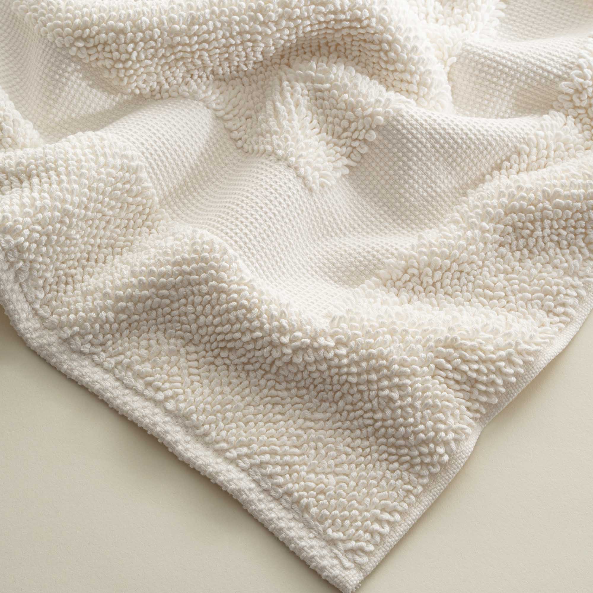 Close-up of the folded Kaia Aegean Cotton Bath Mat in Pearl Petal, showing its plush texture, soft colour, and quality finish