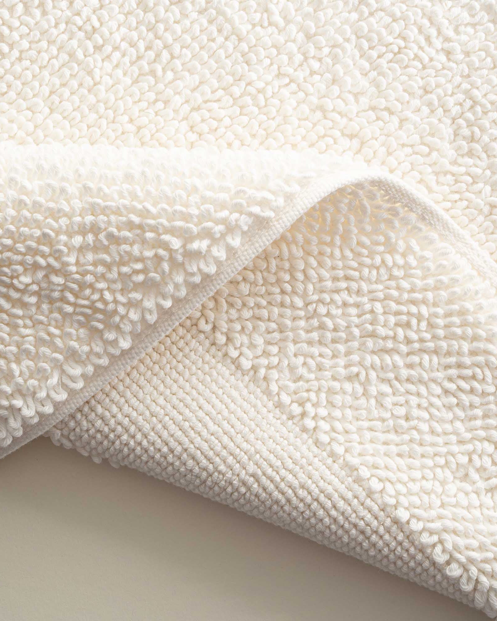 Close-up of the folded Kaia Aegean Cotton Bath Mat in Pearl Petal, showing its plush texture, soft colour, and quality finish