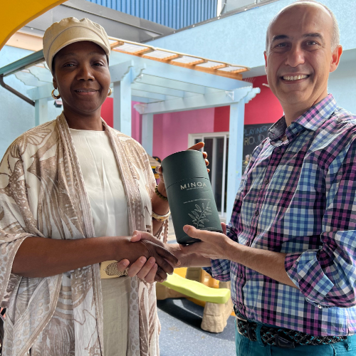 Minoa and Redwoodshelter donation giving one free Minoa's towel to the woman