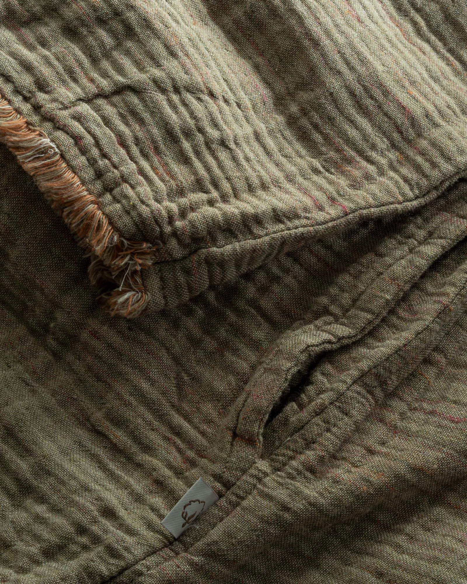 Close-up of Men's Muna Organic Aegean Cotton Gauze Two Sided Robe showing soft, textured, gauze fabric and high-quality stitching