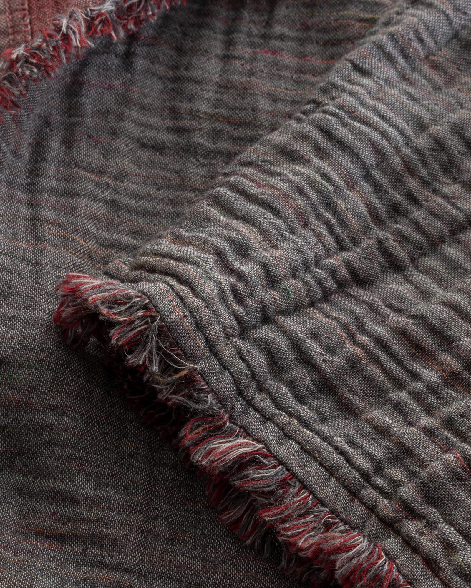 Close-up of the sleeve of the Women's Muna Organic Aegean Cotton Gauze Two-Sided Robe in Bordeaux Bliss, showcasing the fabric's detailed stitching and elegant design
