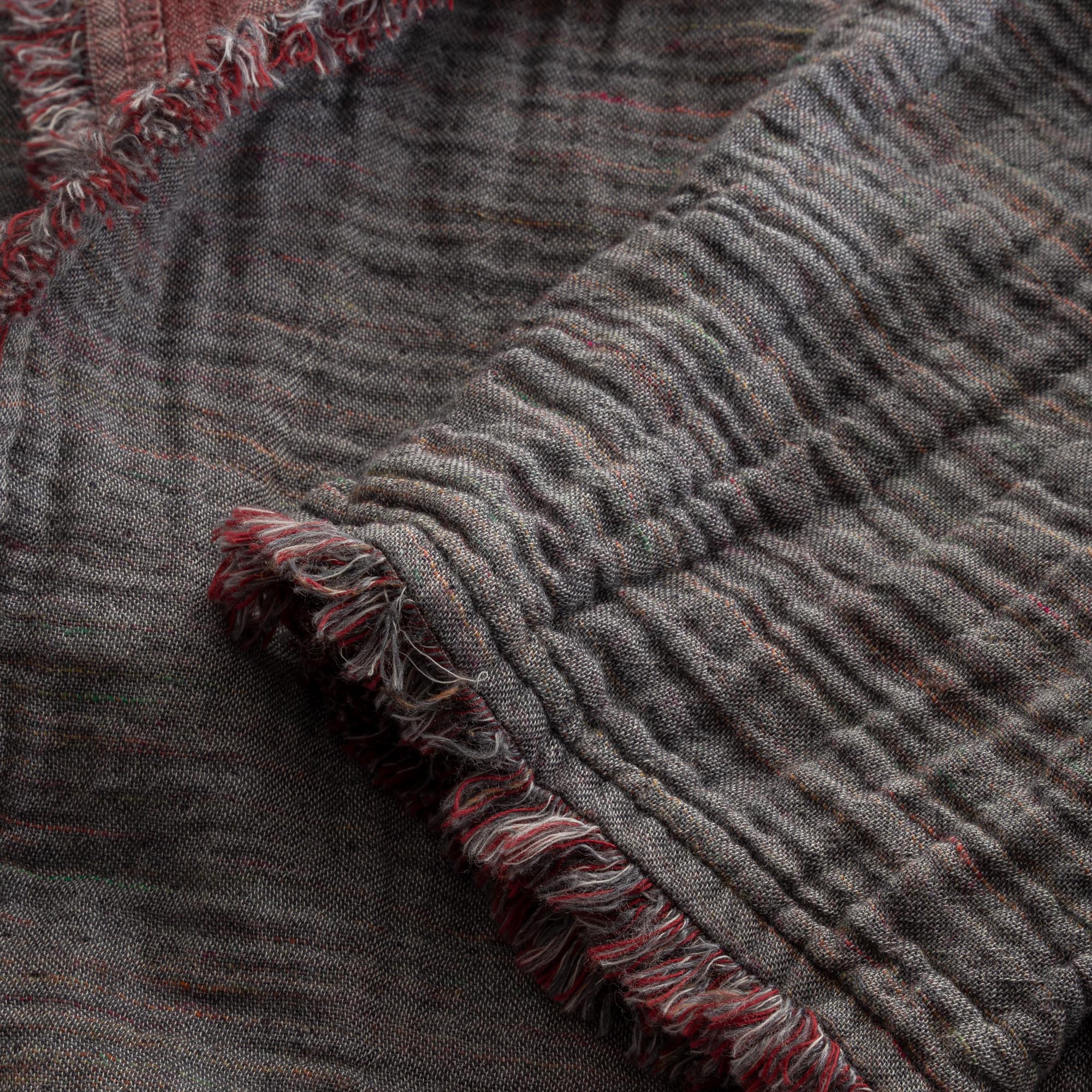 Close-up of the sleeve of the Women's Muna Organic Aegean Cotton Gauze Two-Sided Robe in Bordeaux Bliss, showcasing the fabric's detailed stitching and elegant design