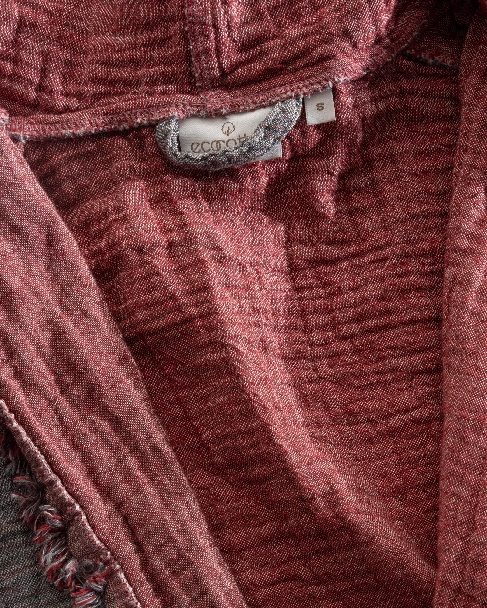 Close-up of the back of the Women's Muna Organic Aegean Cotton Gauze Two-Sided Robe in Bordeaux Bliss, highlighting the Ecocotton tag and the robe's refined design and quality